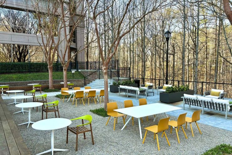 Outdoor tenant patio with tables and chairs among the trees